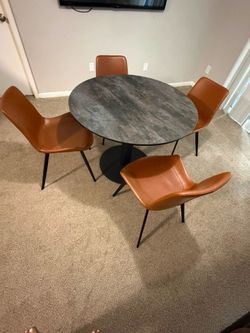 Designer table with an iron leg and a ceramic top