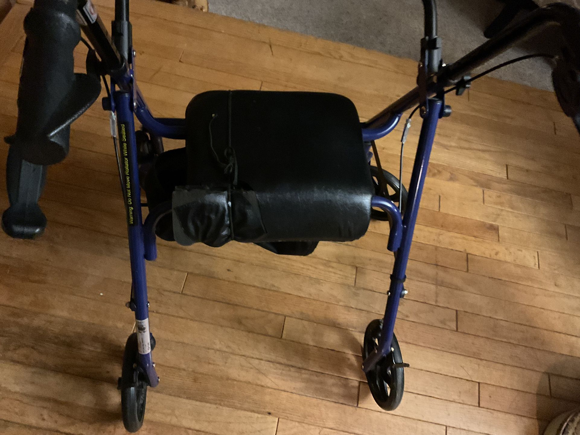 A Folding Black Walker That Can Be Folded And Put Away When Not Using ( There’s A Piece Of The Leather On The Chair Ripped A Little) NO SHIPPING)