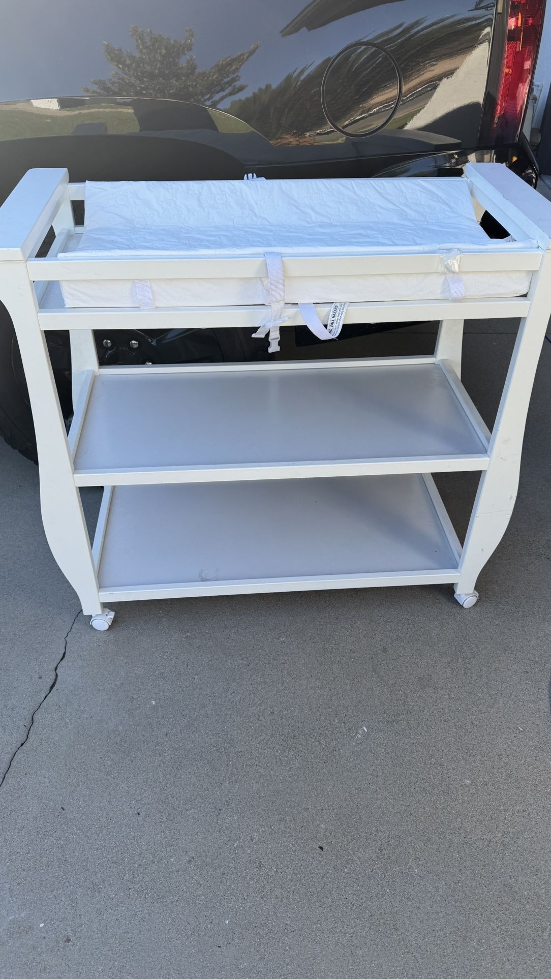 White Delta Children Changing Table with Wheels & Changing Pad