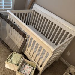 baby crib, sheets, and baby gate