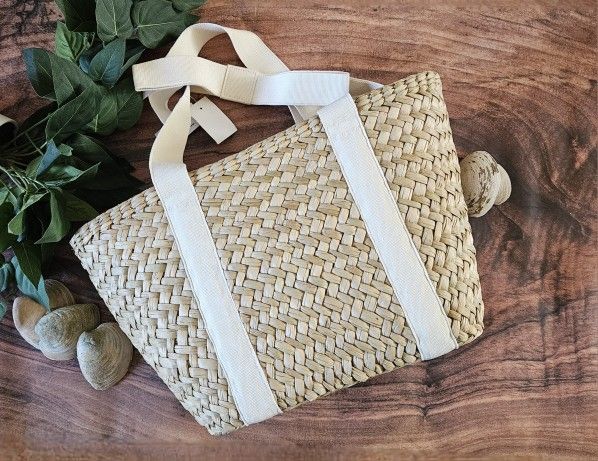 J.Crew nwt straw tote bag with natural canvas straps and bow detail at shoulder approximately 11"h x 16 3/4"w with 9 1/2" drop handle