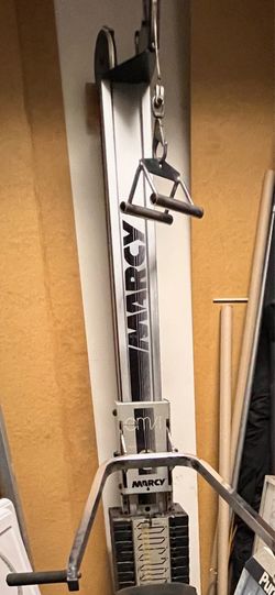 Marcy home gym with weight stack, bench, lat pulldown, and attachments