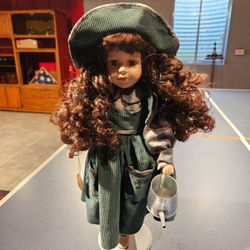 Porcelain Doll In Green Corduroy Dress