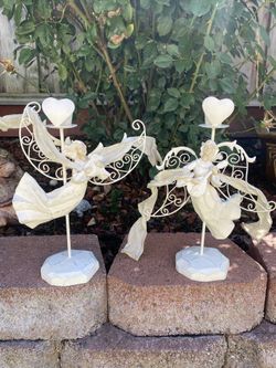 Two white metal angel candle holders