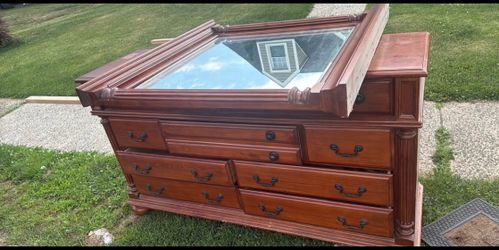 Solid wood the top of the dresser has a little things on top but other than that is in great condition and have a mirror delivery fee curbside drop of