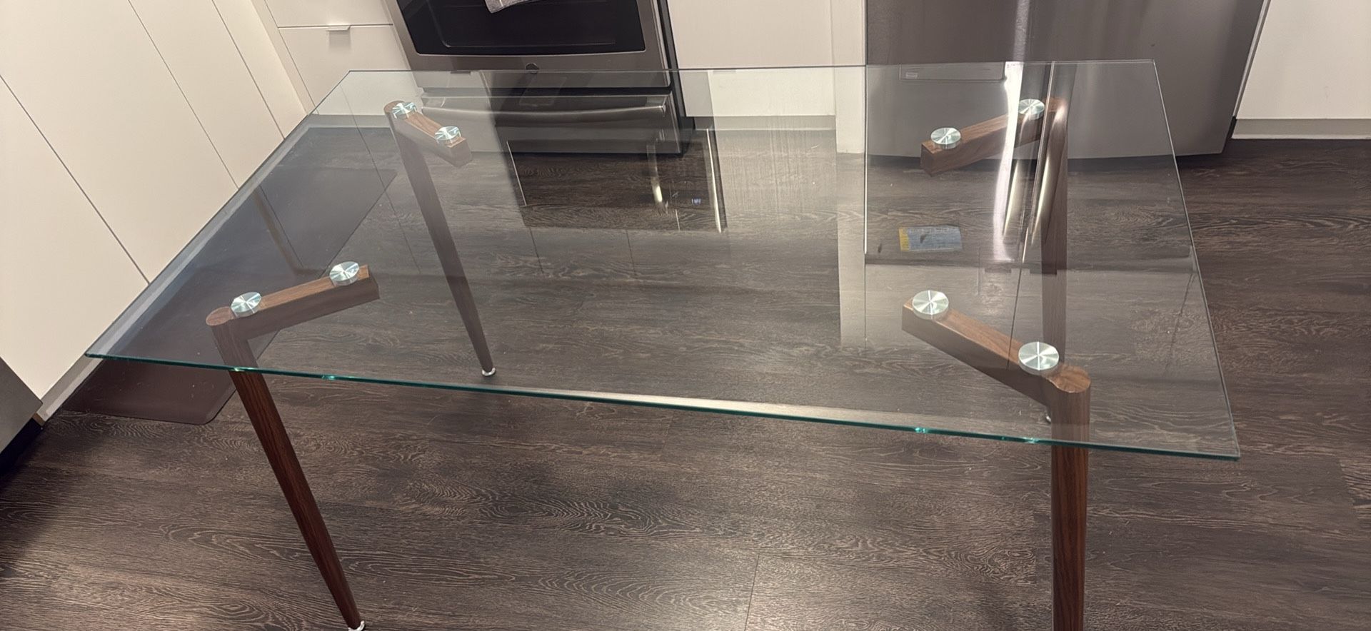 Modern glass rectangular dining table with metal legs in brown walnut finish