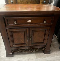 Solid Wood Accent Cabinet / Nightstand. Features 1 drawer and 2 cabinet doors for extra storage. Sturdy and functional. Normal wear from use.