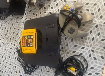 nintendo 64 with one remote and a donkey kong game
