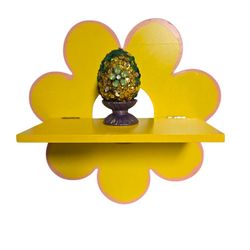 Yellow floral folding wooden shelf with sequin Easter egg in egg cup