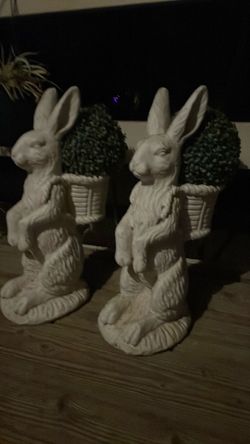 Two ceramic rabbits with baskets and bushes this item is pending pick up for tomorrow