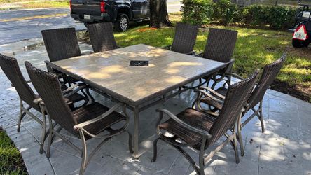 Large outdoor patio table with 8 recliner chairs.. and hole for umbrella . I have 64 k. V