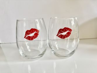 Set of two red lip wine glasses. New. 4” tall 10.75” circumference. They come from a smoke free environment.  