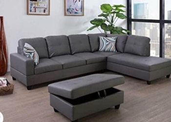 Gray leather sectional couch and ottoman