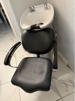 Professional salon shampoo backwash unit with a ceramic bowl and attached chair