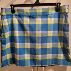Brand New Izod golf skort in blue, yellow, and white plaid. Size 14