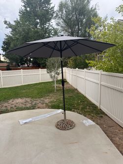 Brand new 9ft umbrella and umbrella base - can deliver.
