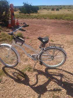 Two bikes, one beach cruiser, one street bike.