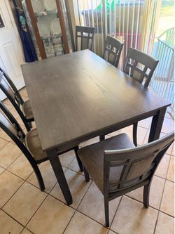 Gray dinning table with 6 matching chair’s