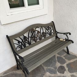 garden bench is a Berkeley Forge Cast Iron and Wood Slatted Garden Bench, featuring an ornate backrest pattern