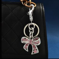 silver keychain with a pink bow design New In The Box