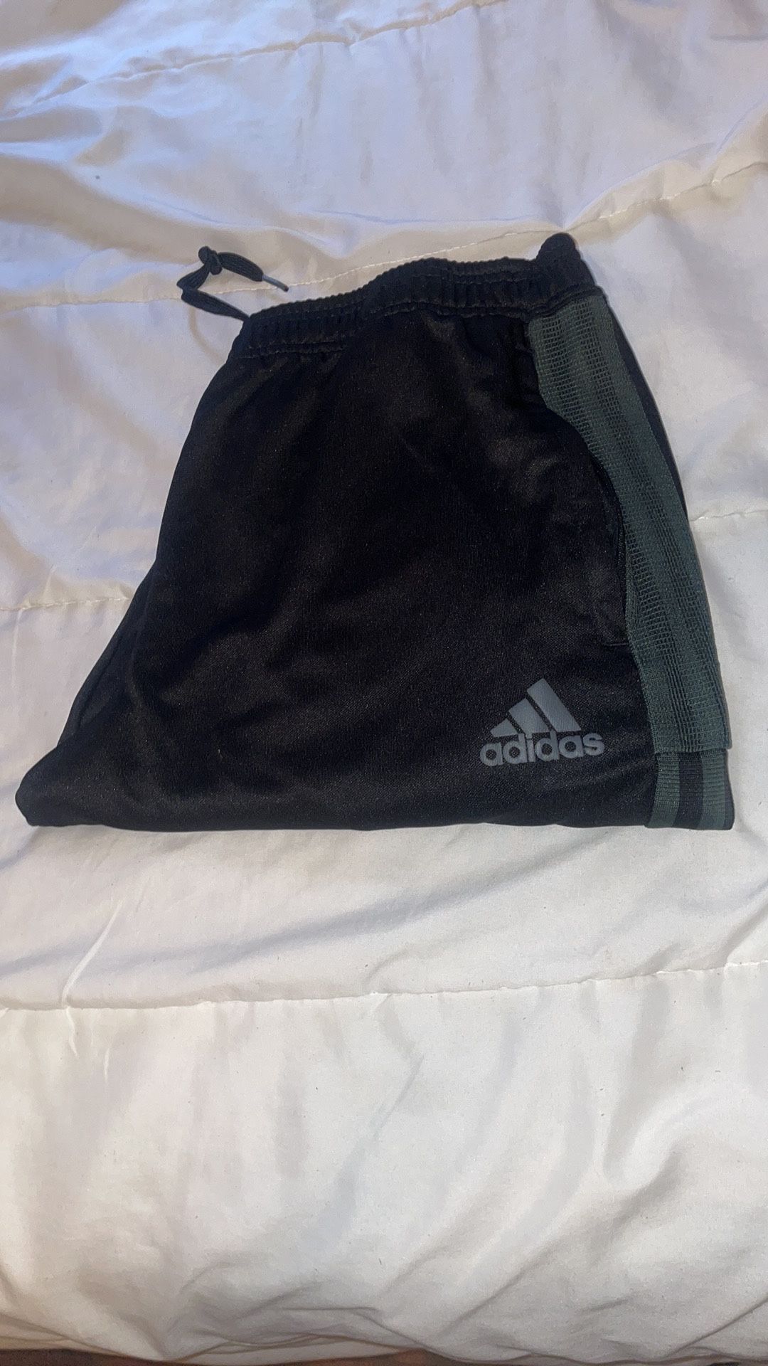 Adidas Black and Green Stripes track pants with zipper on the bottom leg.