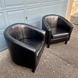 2 handsome black barrel chairs