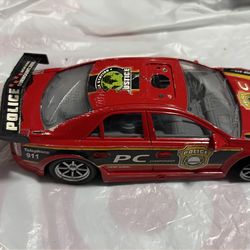Police.  Pc. Car color red trim with black