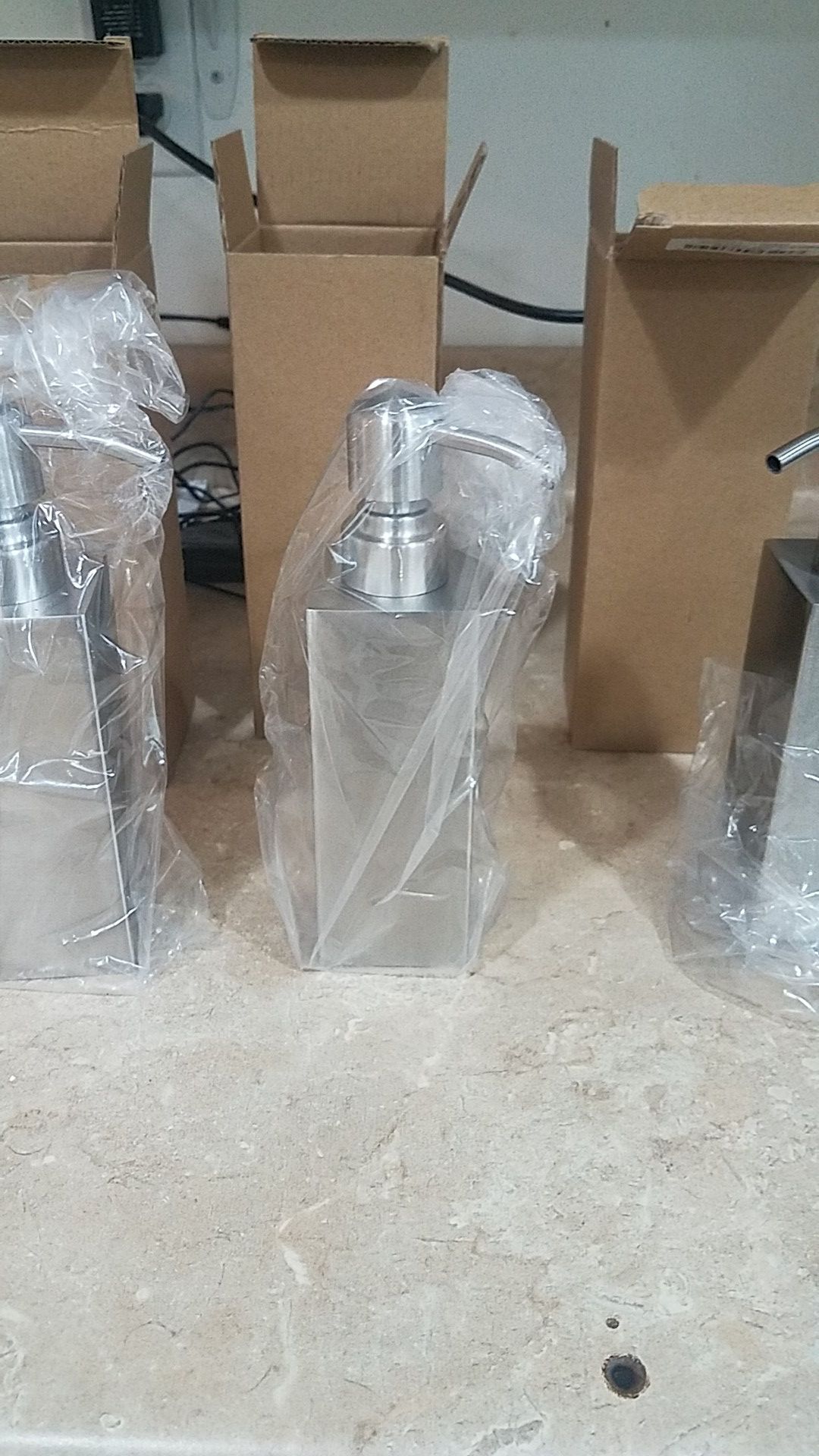 3 stainless steel soap dispensers.