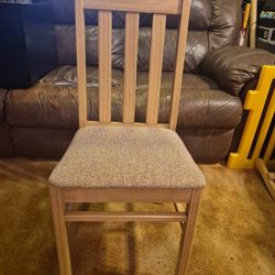 Light tan wooden cushioned chair. Very good condition. Seat 15 by 15. Total height 34.