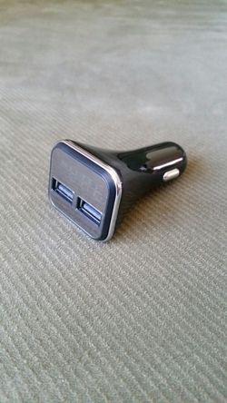 Dual USB car charger with voltage display.