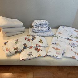 Naturepedic 2-stage Crib & Toddler Mattress, Naturepedic Mattress Covers, & Pottery Barn Sheet Sets (Paw Patrol & Finding Nemo)