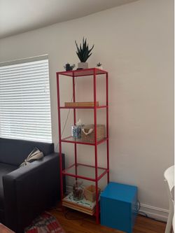 Red metal open storage shelf