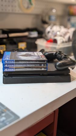 Sony PS4 and three games.