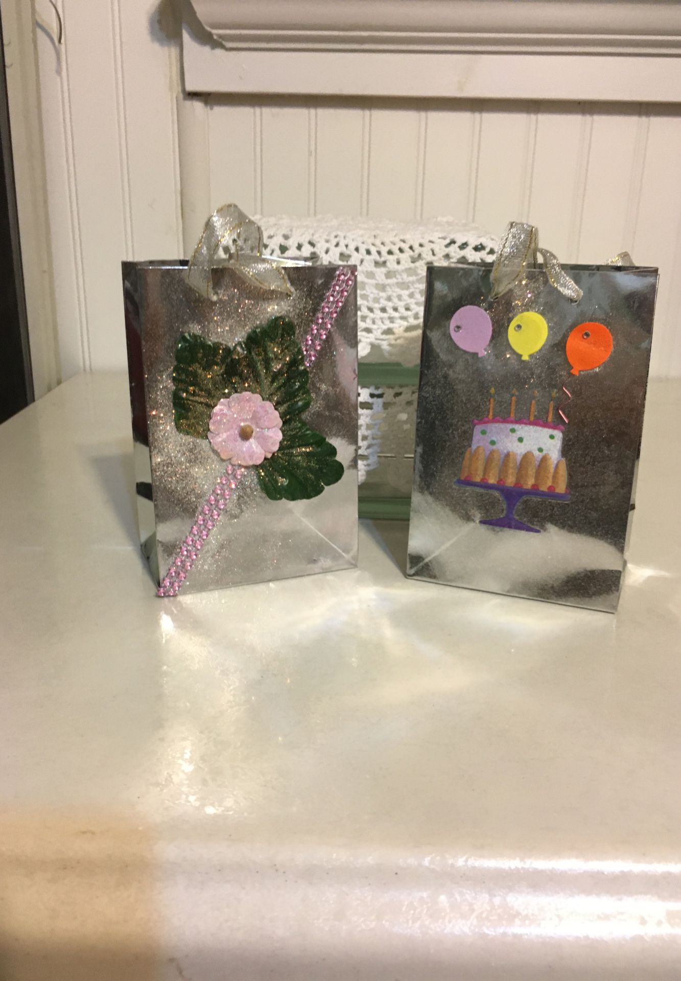 A pair of hand decorated small gift bags