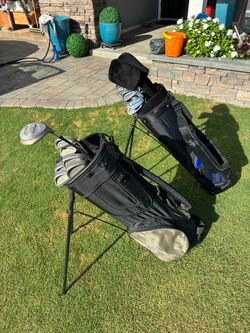 Two sets of golf clubs,  bags included