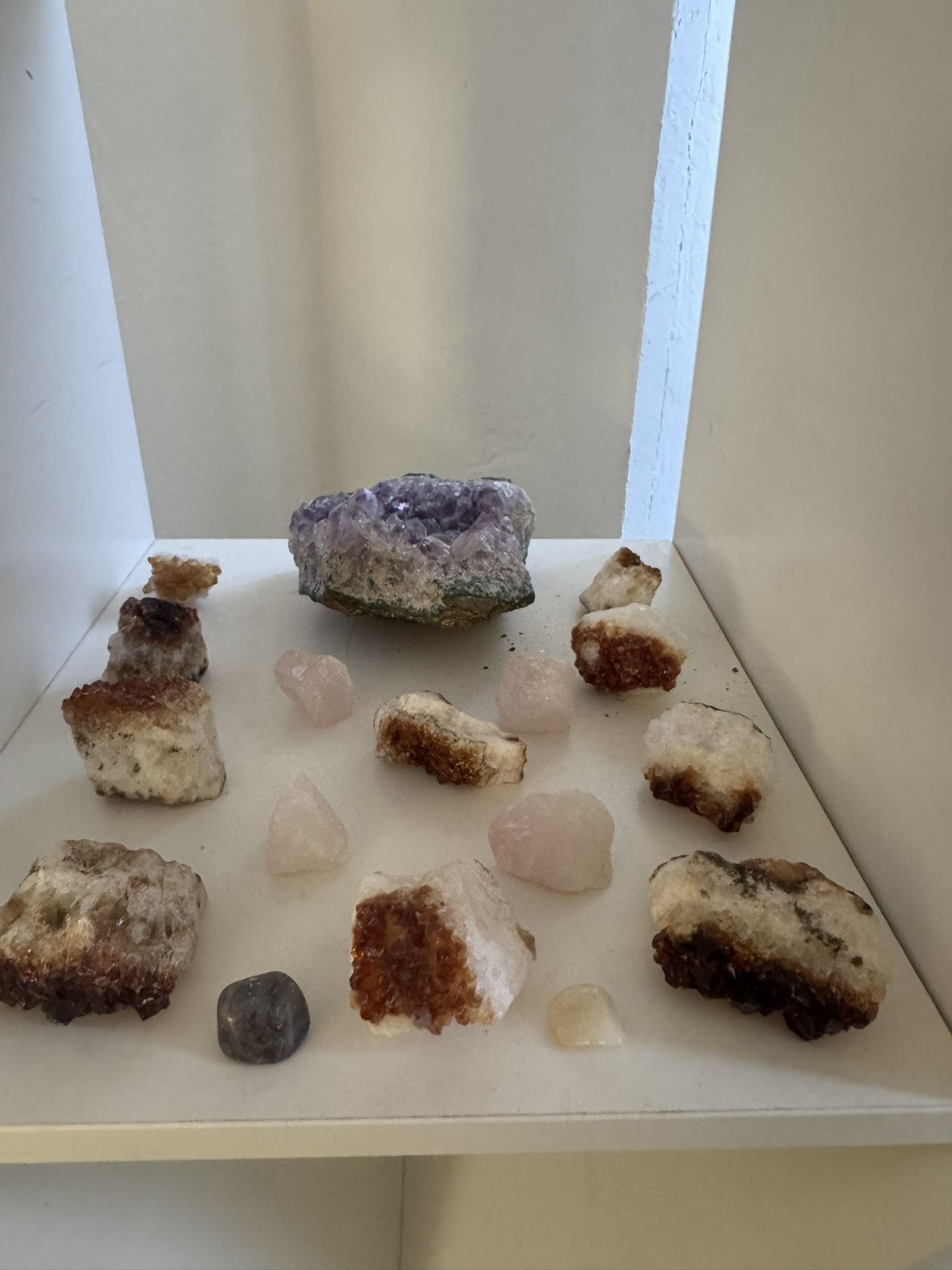 4. Image 4 (Crystals and Minerals Display) • Display shelf with crystals • Amethyst cluster (top center) • Citrine or calcite stones (brown and whi