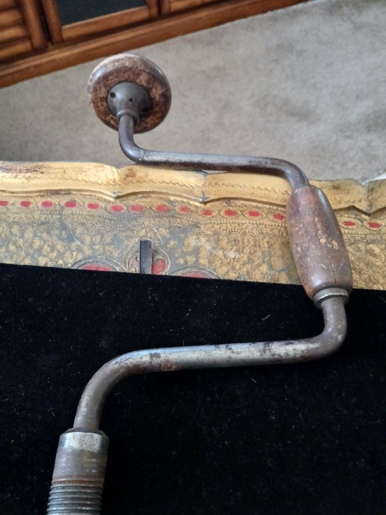 Old Hand Drill And Old Pipe Wrench.