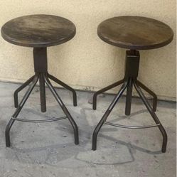 Two wood and iron adjustable height bar stools both for 110