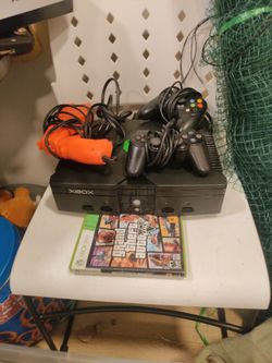 X-box 360 remotes, gun, grand theft auto game, guitar hero in box