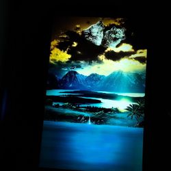 LED art frame or light-up painting. This specific piece features a landscape with wolves, mountains, a lake, and a waterfall. 