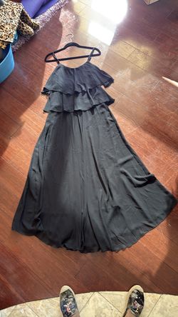 Brand see you Monday. This is an all black long really at the top blow at the bottom string straps. I believe it can fit a small or medium person.