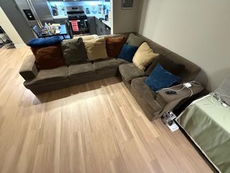 Large L-shaped sofa with pullout mattress pillows included Large L-shaped sofa with pullout mattress pillows included