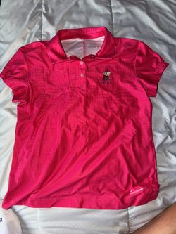 Pink and white polka-dotted Nike Golf Dri-FIT polo features an embroidered sailing ship logo above the word "Cabot" size youth large