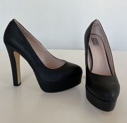 Black vegan leather Platform Heel. Women's Size 8.5. Worn once. No scratches. 5 inches platform