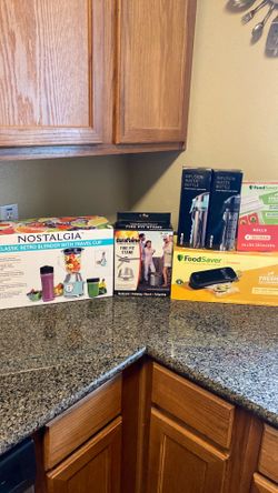 Blender, fire pit stand, two water bottles, and food saver with bags. UNOPENED