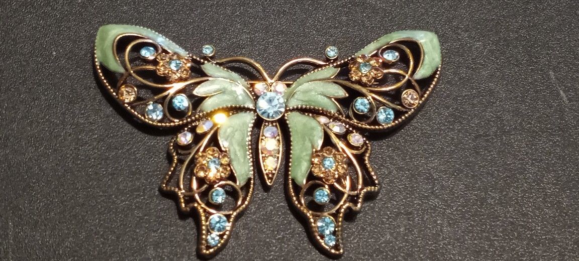 A beautiful vintage Avon enameled butterfly brooch with rhinestones.