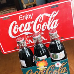 OLYMPIC 1995 YEAR TO GO COMMEMORATIVE SET OF COKE COLA EMBOSSED BOTTLES IN CARRY CASE WITH LICENSE COKE COLA PLATE SET OF LIMITED 6