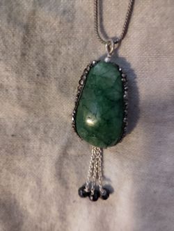 55.7ct. natural Green Emerald on both sides /4.5 cts of black carbonado diamonds