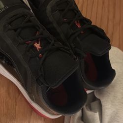 Air Jordan 11 CMFT Low “Bred”.Black, Red, and White. The shoe is a size 8 in Men.