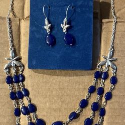 Blue beaded and silver toned necklace and earring set.